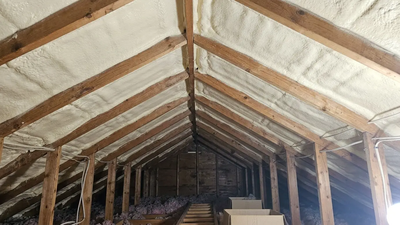 After: Bare roof deck sealed with spray foam | Music City Insulation After: an attic roof deck with smooth spray foam insulation sealing the underside of the roof deck between the rafters