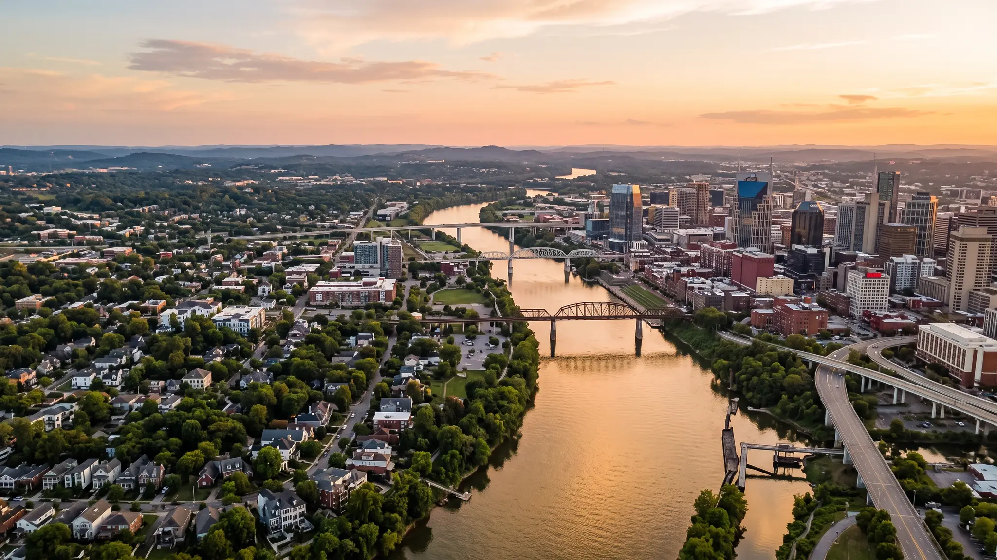Insulation service areas in Middle Tennessee | Music City Insulation Aerial view of the Cumberland River winding past the Nashville skyline and Middle Tennessee neighborhoods at sunset